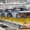 Automotive bodies moving on a friction conveyor system in a manufacturing plant